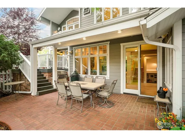 a view of a patio with table and chairs and wooden floor