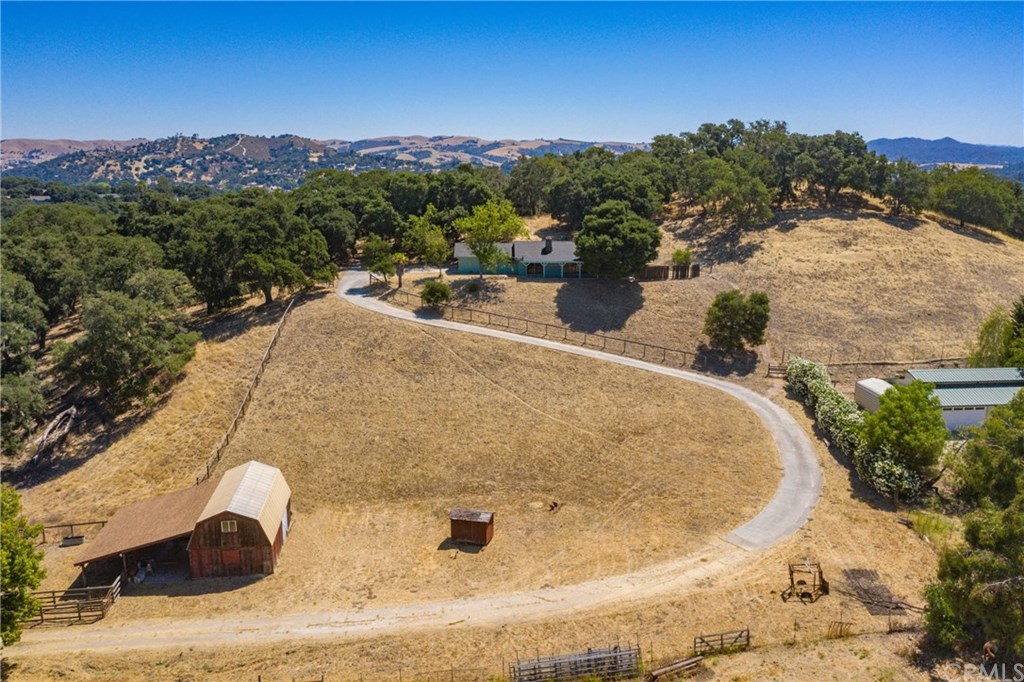 West side ranchette on 2.44 acres with barn and single level home at the top of the driveway.