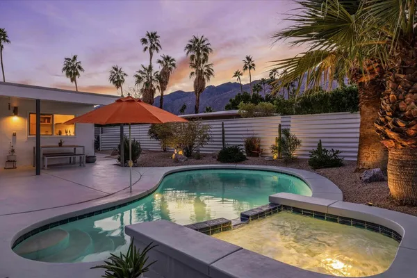 swimming pool view with a seating space