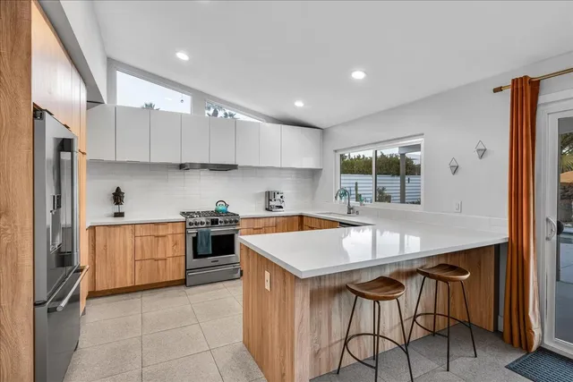 a living room with furniture and paintings on the wall