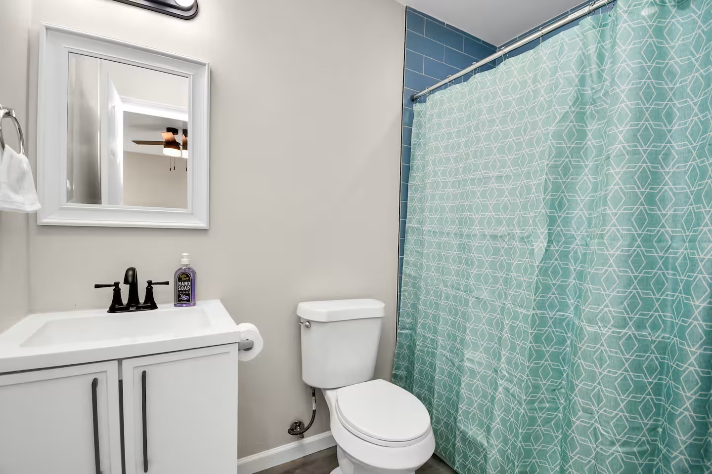 3318 Wichita Street Houston, TX 77004 - Photo 31 of 36 a bathroom with a toilet a sink and a mirror