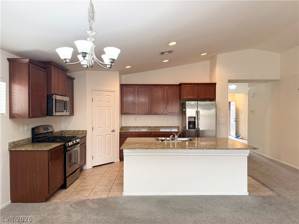 8231 Buffalo Ranch Avenue Las Vegas, NV 89147 - Photo 3 of 22 A well-appointed kitchen features rich wood cabinetry, granite countertops, and modern stainless steel appliances.