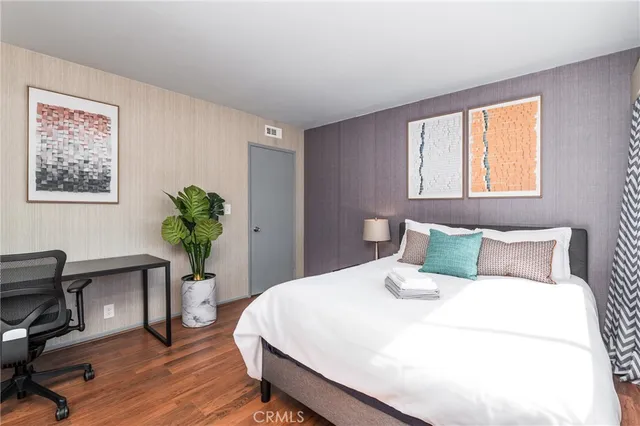 a bedroom with a bed and a potted plant