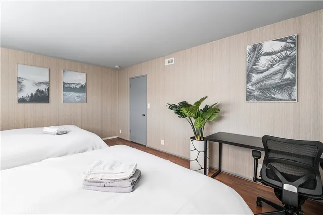 a bedroom with a bed and a potted plant