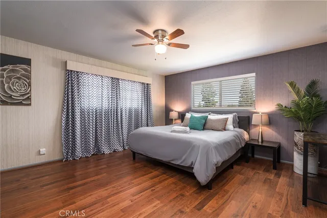 a bedroom with a large bed and a chandelier