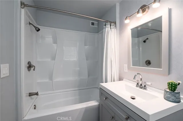 a bathroom with a sink mirror toilet and bathtub