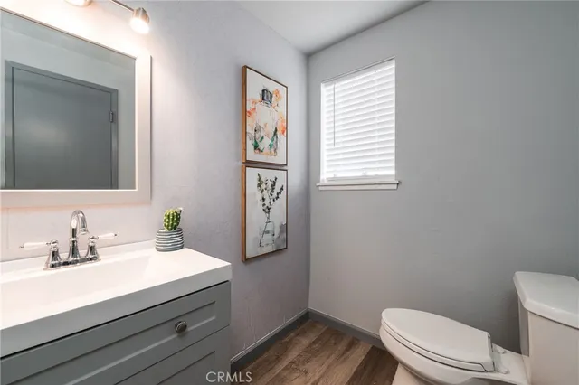 a bathroom with a sink a mirror and a toilet