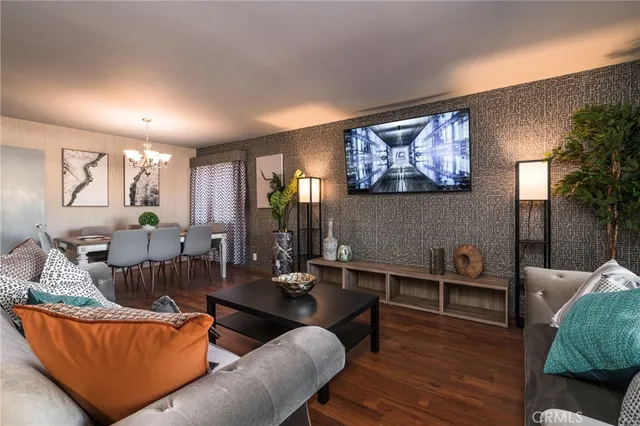 a living room with furniture a wooden floor and a large window
