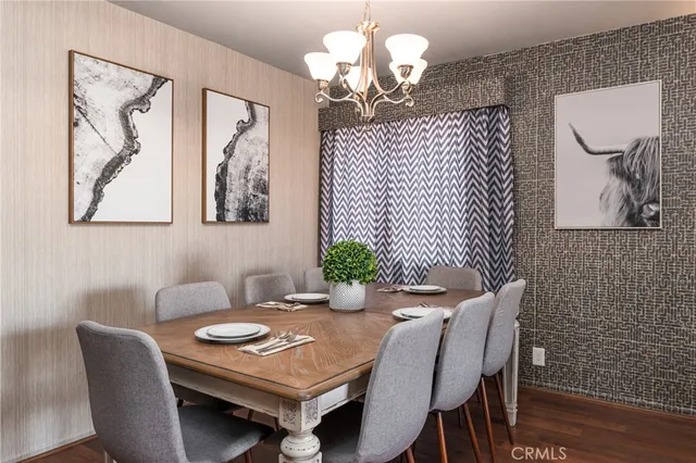 a view of a dining room with furniture wooden floor and a chandelier