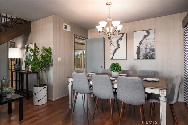 a view of a dining room with furniture wooden floor and chandelier