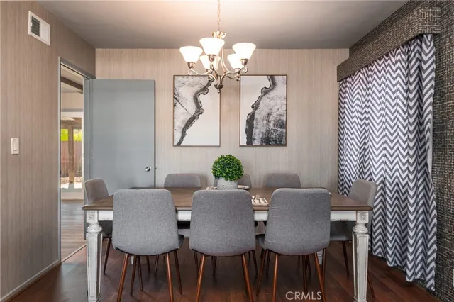 a view of a dining room with furniture and chandelier