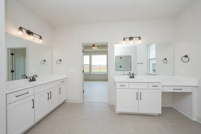 an empty room with a window and a ceiling fan