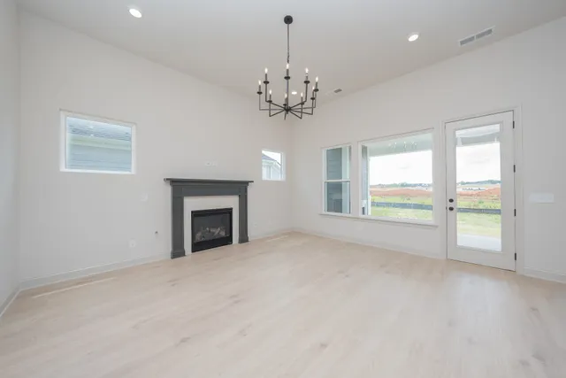 a view of a kitchen with refrigerator and windows