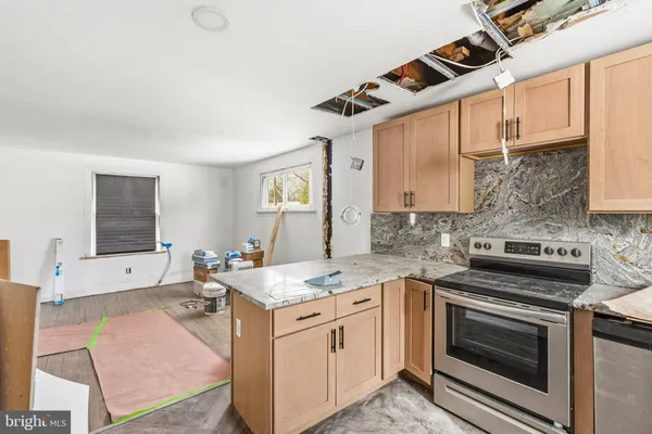a kitchen with a stove oven and sink