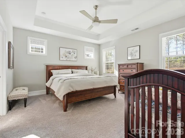 a bedroom with a bed and a chandelier