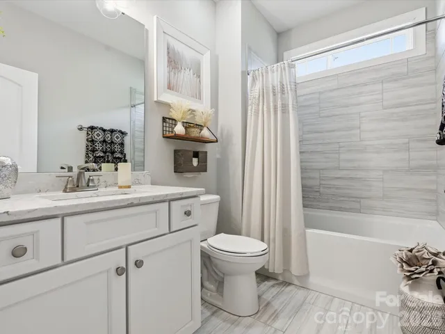 a living room with stainless steel appliances kitchen island a stove and a refrigerator