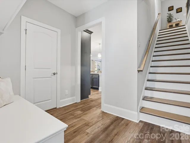 a view of a hallway with furniture and staircase