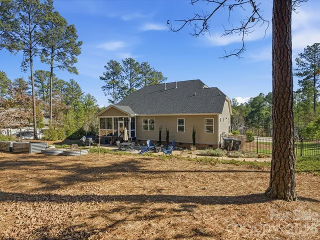 a view of a house with backyard sitting area and garden