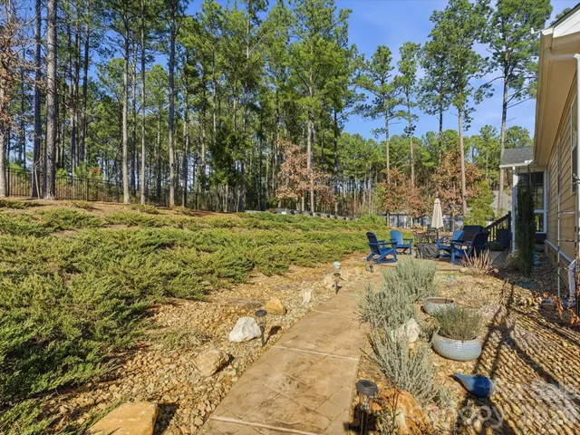 a view of a backyard with sitting area