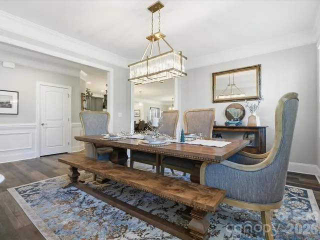 a dining room with furniture wooden floor and a rug