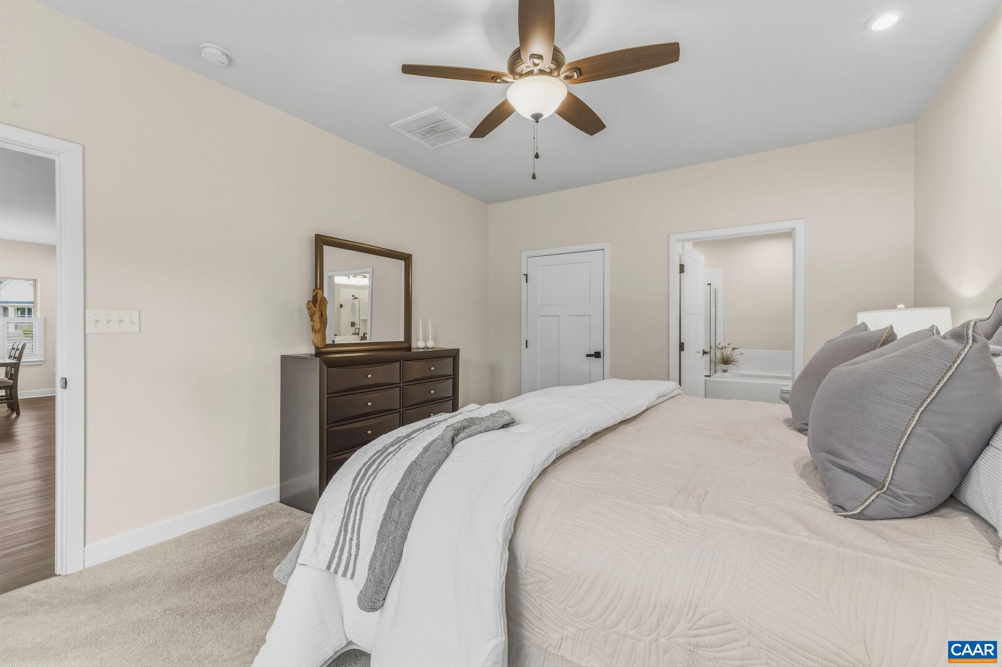 360 Winding Road Keswick, VA 22947 - Photo 29 of 48 a bedroom with a bed and a chandelier