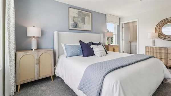 a bedroom with bed and a night stand