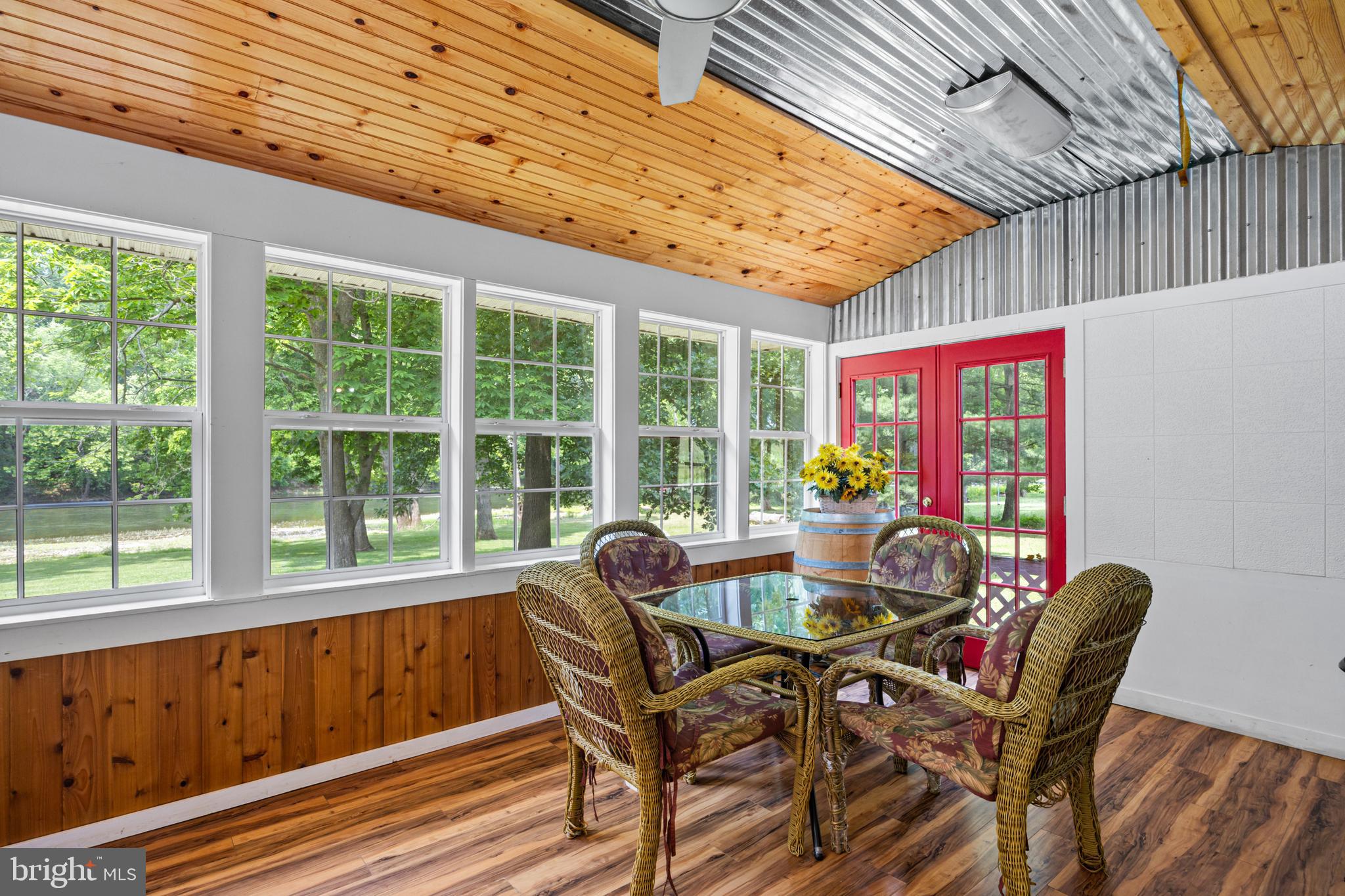 1215 Fort Stover Road Luray, VA 22835 - Photo 103 of 143 a dining room with furniture wooden floor and a potted plant