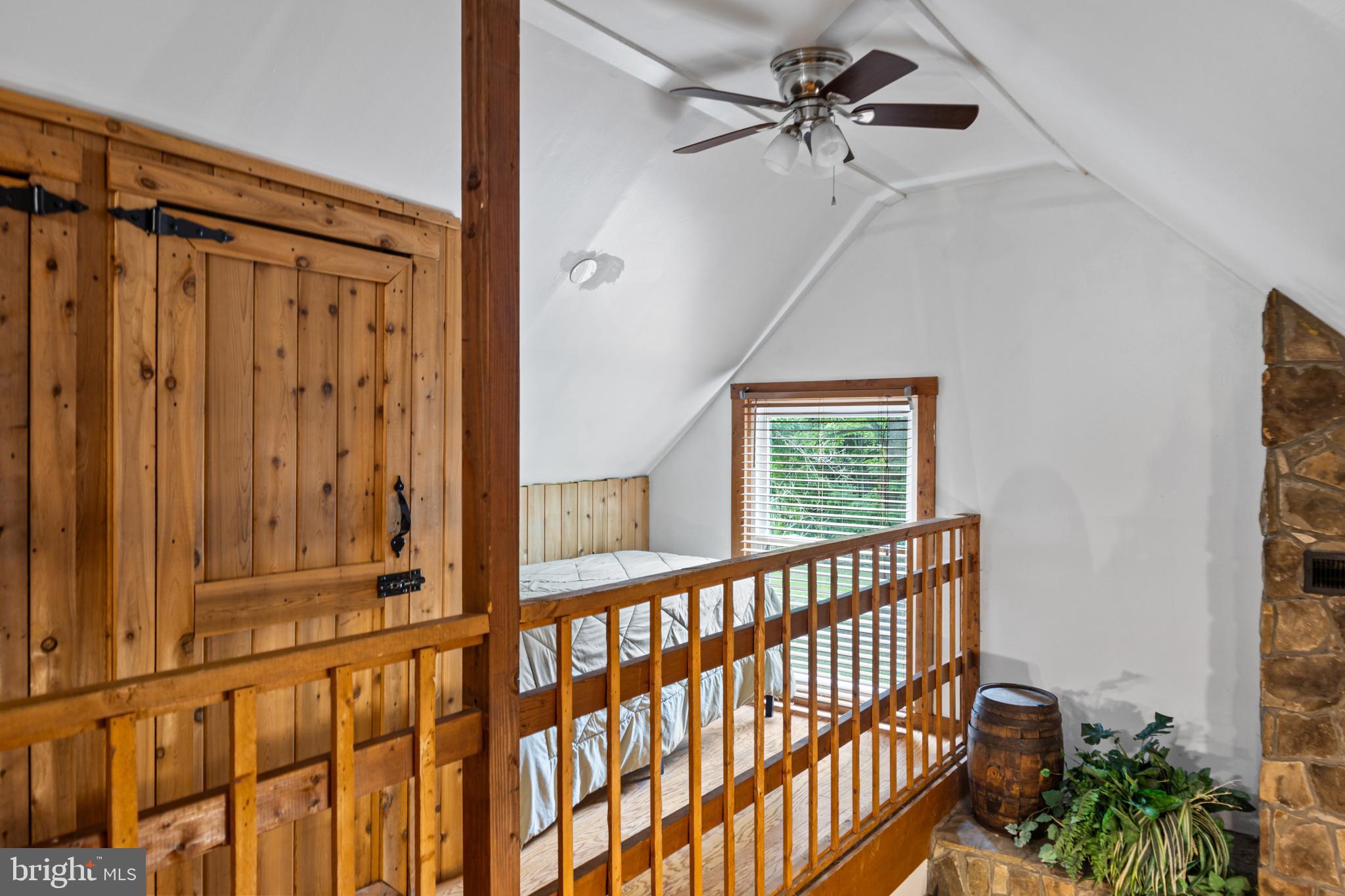 1215 Fort Stover Road Luray, VA 22835 - Photo 114 of 143 a view of a balcony with a ceiling fan and wooden floor