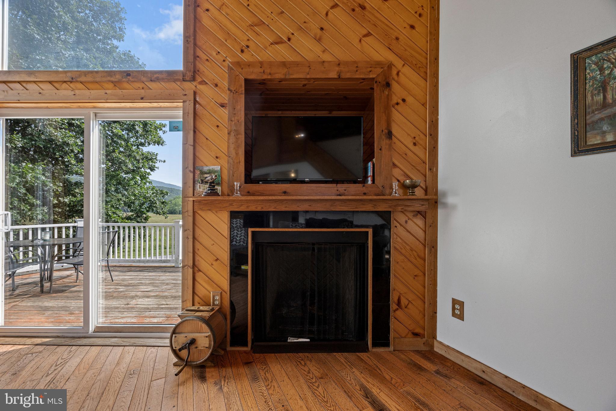 1215 Fort Stover Road Luray, VA 22835 - Photo 17 of 143 a view of a livingroom with wooden floor and a fireplace