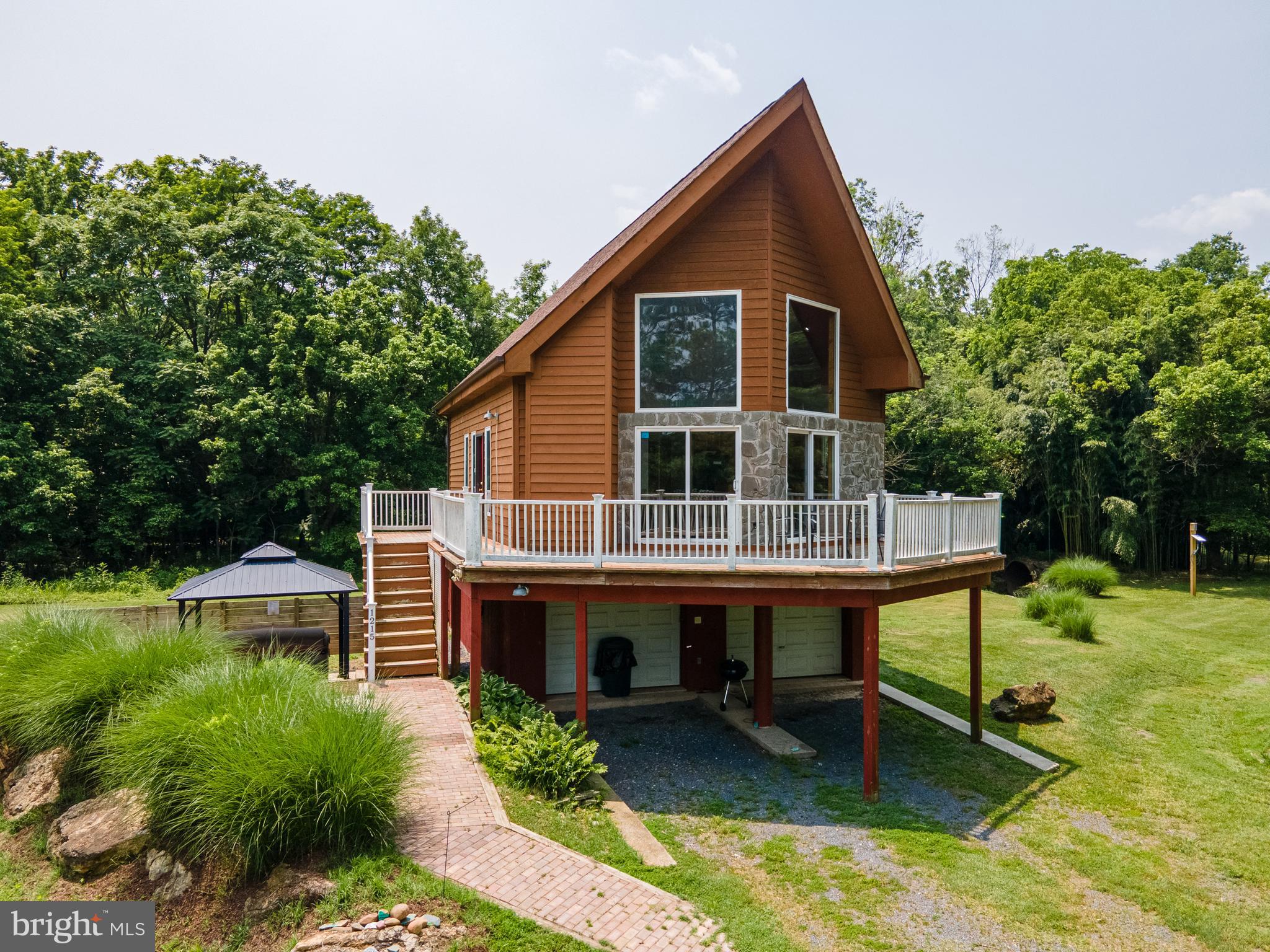 1215 Fort Stover Road Luray, VA 22835 - Photo 3 of 143 a front view of a house with a yard table and chairs