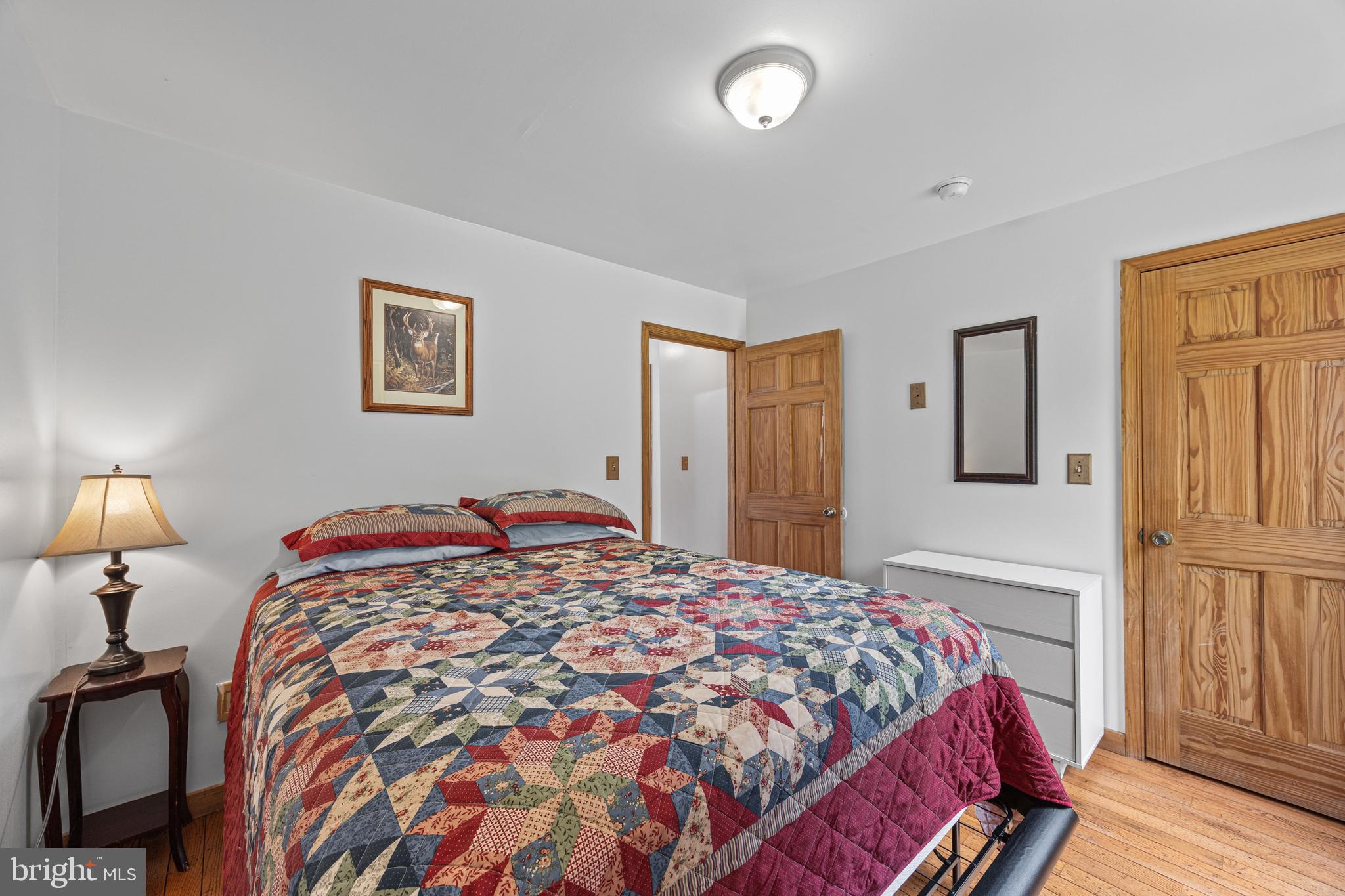 1215 Fort Stover Road Luray, VA 22835 - Photo 34 of 143 a bedroom with a bed and a lamp on table