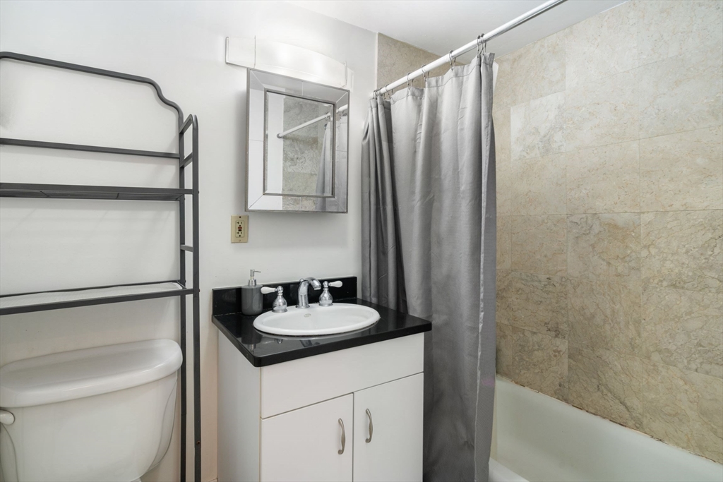 251 Roxbury Street, Unit 2 Boston, MA 02119 - Photo 11 of 16 a bathroom with a sink and a mirror