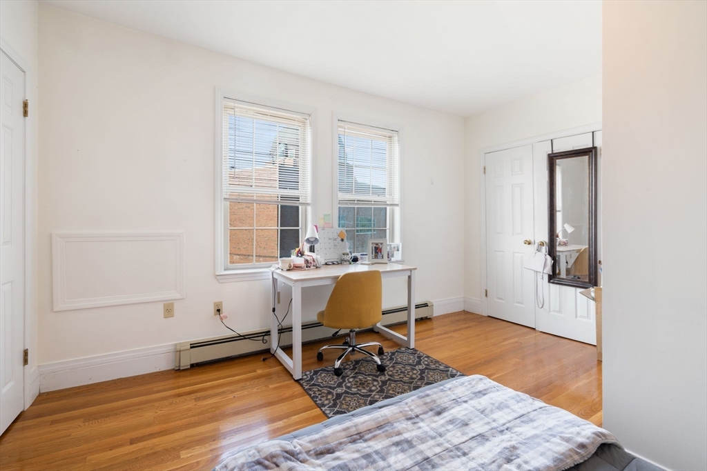 251 Roxbury Street, Unit 2 Boston, MA 02119 - Photo 14 of 16 a workspace with wooden floor and a window