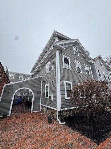 251 Roxbury Street, Unit 2 Boston, MA 02119 - Photo 16 of 16 a front view of a house with parking space