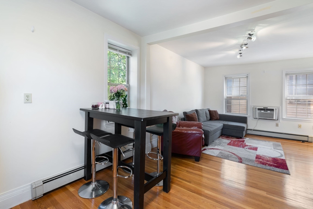 251 Roxbury Street, Unit 2 Boston, MA 02119 - Photo 4 of 16 a living room with furniture and wooden floor