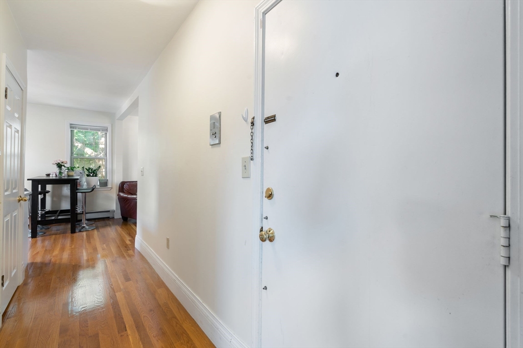251 Roxbury Street, Unit 2 Boston, MA 02119 - Photo 7 of 16 a view of a room with wooden floor