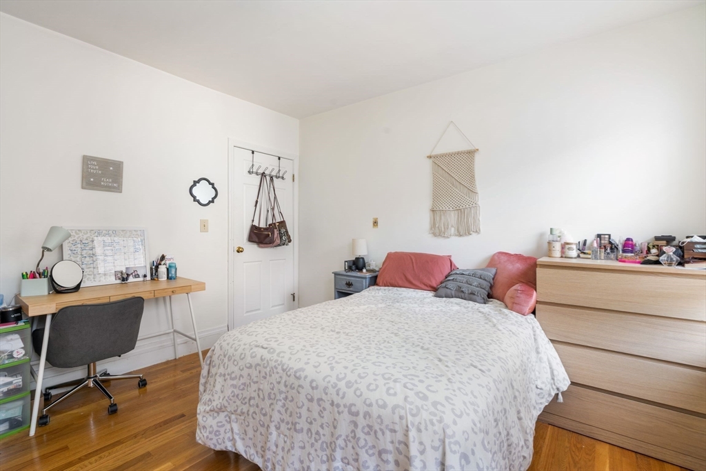 251 Roxbury Street, Unit 2 Boston, MA 02119 - Photo 9 of 16 a bedroom with a bed and a desk