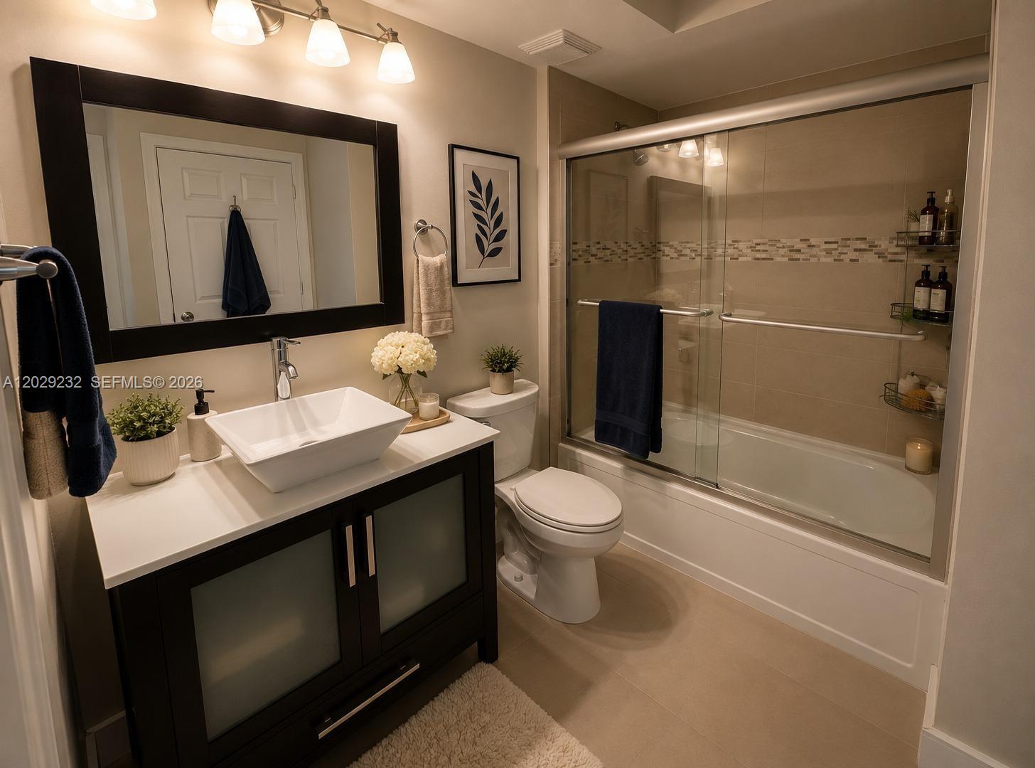 17100 North Bay Road, Unit 1605 Sunny Isles Beach, FL 33160 - Photo 29 of 52 a bathroom with a sink a toilet and shower