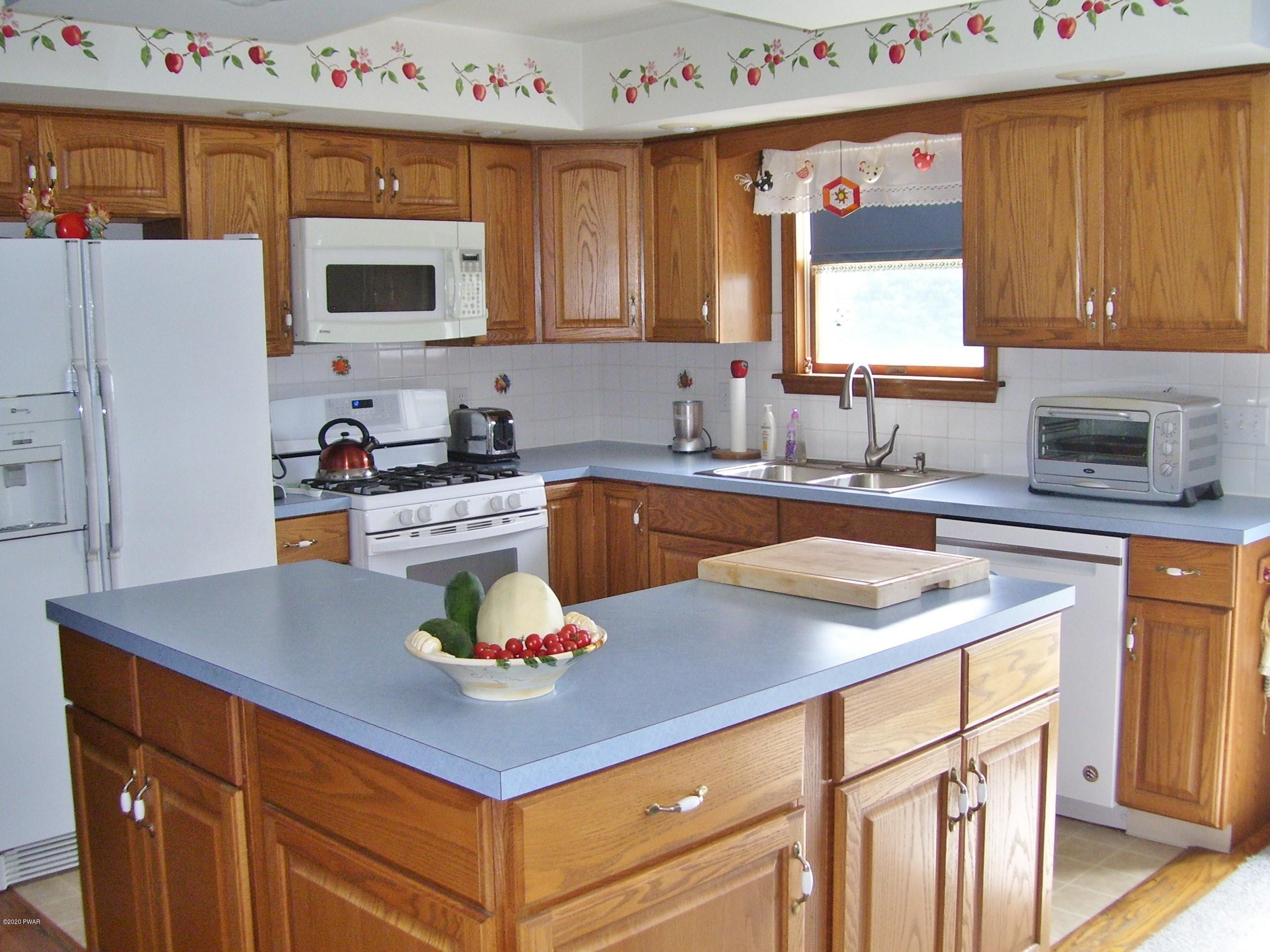 50 Layton Road Waymart, PA 18472 - Photo 14 of 61 a kitchen with granite countertop a sink a stove and cabinets