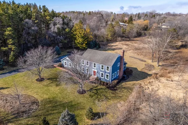a view of a house with a yard covered with snow in the background