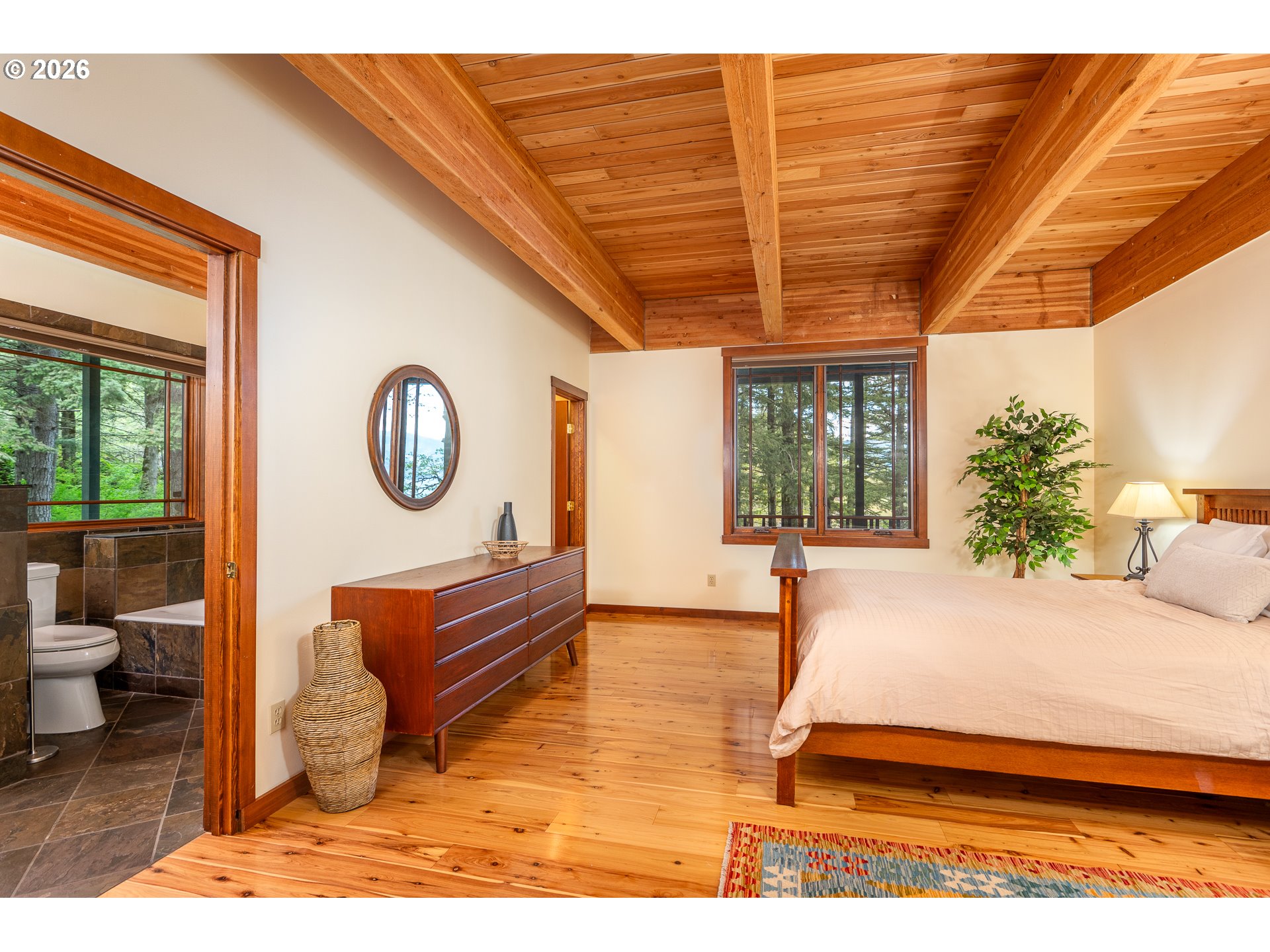 47742 Highway 14 Stevenson, WA 98648 - Photo 17 of 48 a bedroom with a bed and a large window