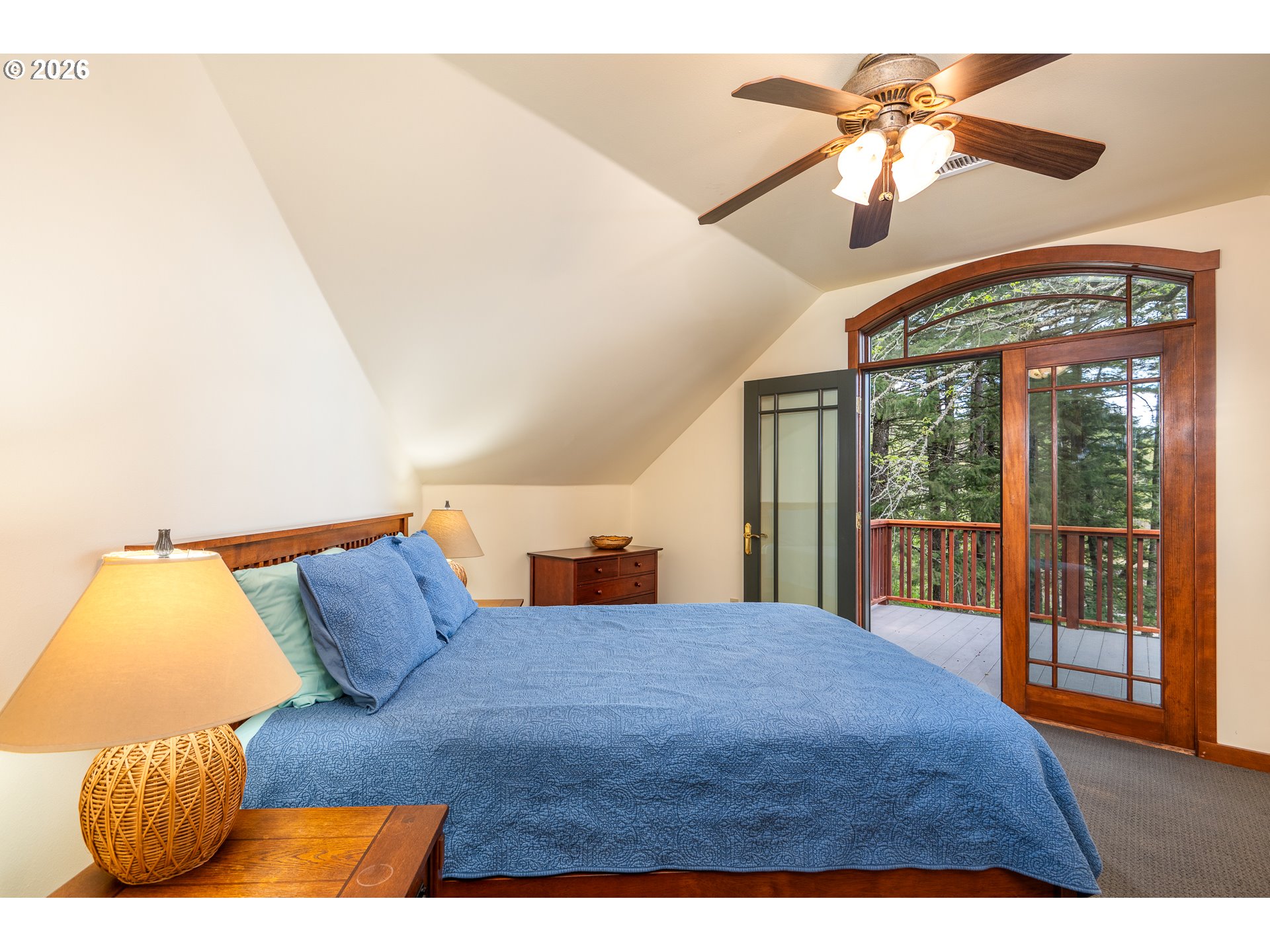 47742 Highway 14 Stevenson, WA 98648 - Photo 21 of 48 a bedroom with a large bed and a chandelier