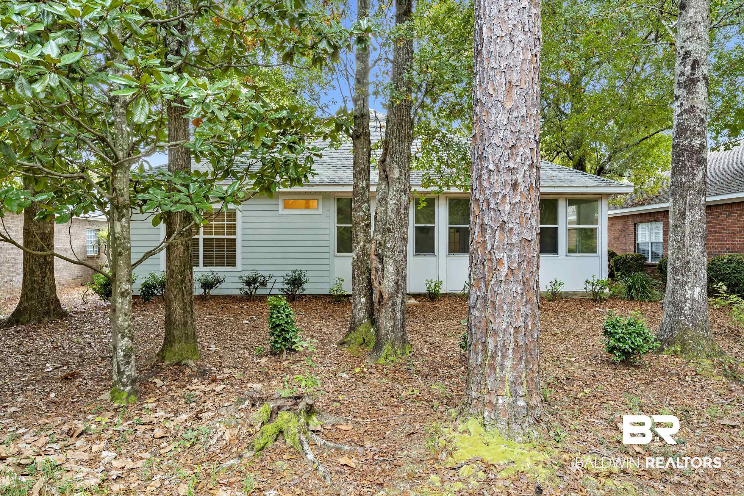 105 Mark Twain Loop Foley, AL 36535 - Photo 22 of 43 View of front of house featuring a sunroom and a shingled roof