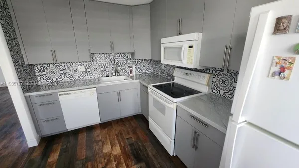 a kitchen with white cabinets sink and white appliances