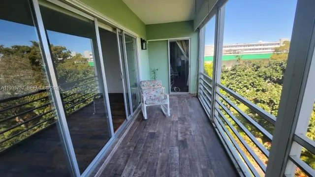 a balcony with chairs and wooden floor