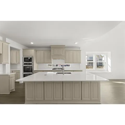 a kitchen with stainless steel appliances kitchen island a sink stove and refrigerator