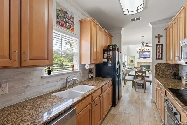 a kitchen with a stove a sink and a refrigerator