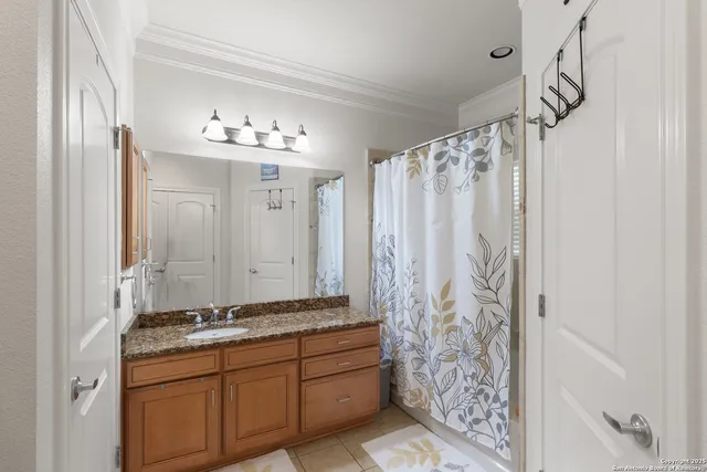 a bathroom with a double vanity sink and a shower