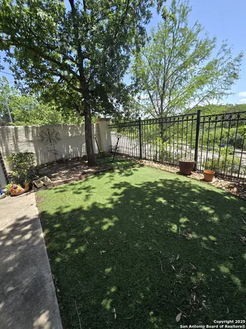 a swimming pool with trees in the background