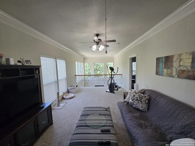 a living room with furniture a large window and flat screen tv